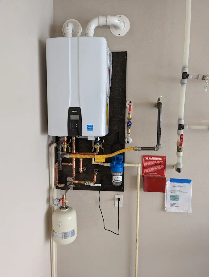 Professional plumber installing copper piping in a Medina home